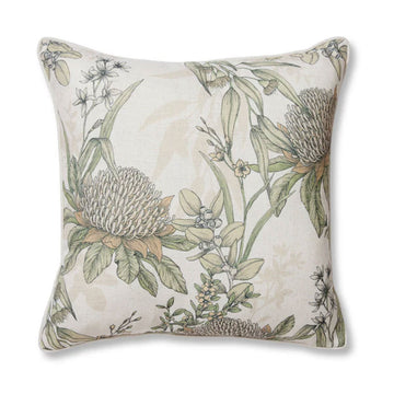 A square cushion in a neutral colour illustrated with green flowers and leaves.