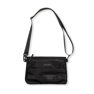 Front view of a black cross body bag with a zip pocket on the front.