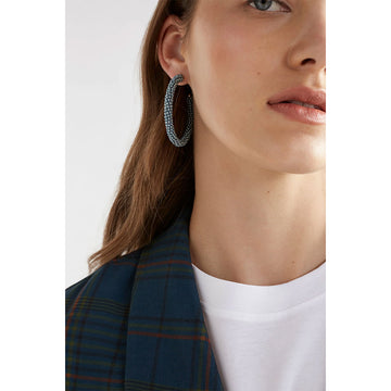 A pair of hoop earrings made up of tiny denim coloured beads.