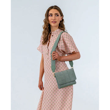 Front view of a satchel style bag in sage in a quilted design.
