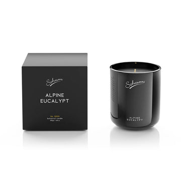 A black glass candle next to a matching black cube box with the text 'Alpine Eucalypt' on the front.