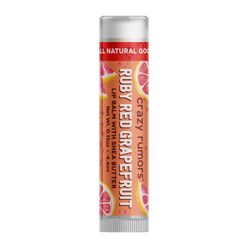 A tube of lip balm with the heading 'Ruby Red Grapefruit' and illustrations of grapefruit on the orange label.