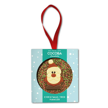 Chocolate Christmas tree hanger with Santa Claus design on a light blue background.