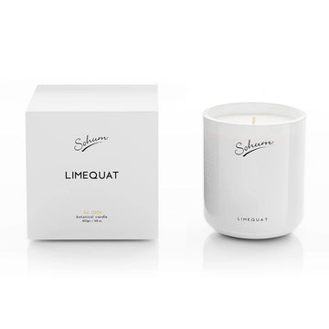 A white glass candle next to a matching white cube box with the text 'Limequat' on the front.