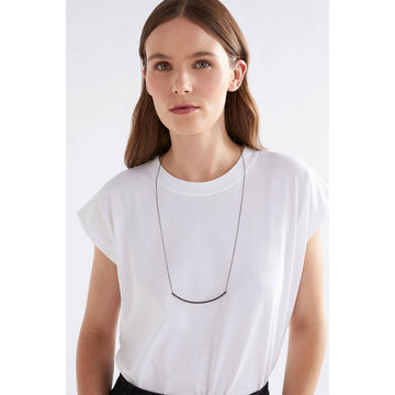 A fine chain necklace in silver with a rounded bar along the middle.