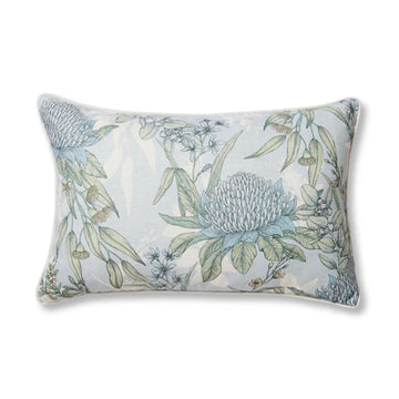 A rectangle cushion in light blue illustrated with blue and green flowers and leaves.