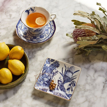 A square trinket tray illustrated with birds and flowers in blue.