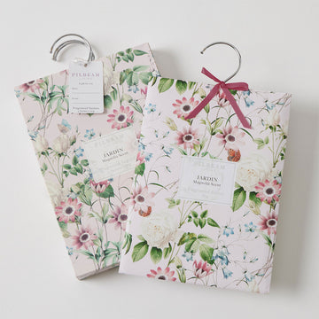 Hanging sachets pictured with packaging illustrated with flowers.