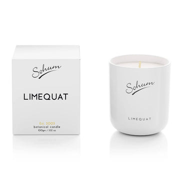 A white glass candle next to a matching white cube box with the text 'Limequat' on the front.