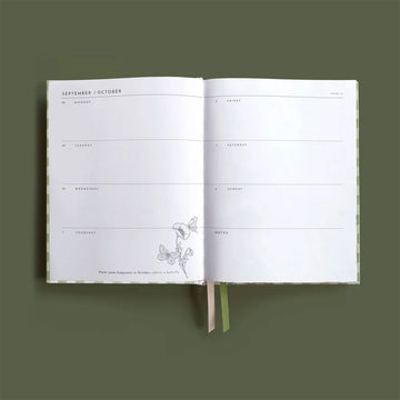 2026 planner with green checkered design and floral elements on a green background.