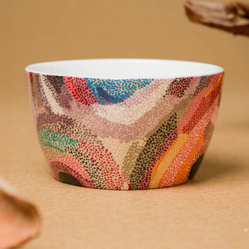 A ceramic bowl printed with artwork by Marianne Burton.