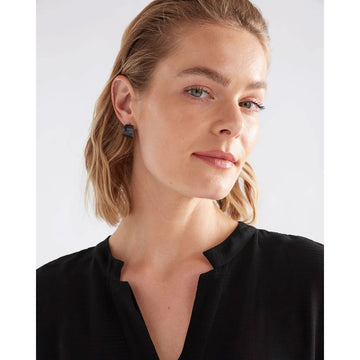 Small navy hoop earrings on a light grey background.