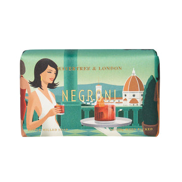 A rectangle bar of soap wrapped up in packaging with an illustration of a woman having a drink on a balcony looking over a city.