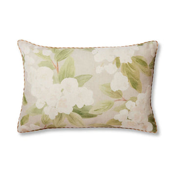 A rectangle cushion in neutral colours illustrated with white flowers.