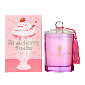 A glass candle in pink next to a box with the heading 'Strawberry Shake' and an illustration of a strawberry milkshake.