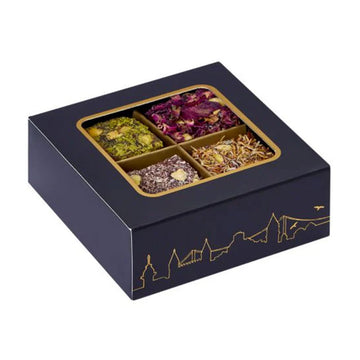 Navy blue tea box with gold detailing containing assorted Turkish delight.