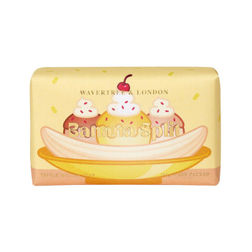 A rectangle bar of soap wrapped in yellow packaging with the heading 'Banana Split' with an illustration of a banana split sundae.