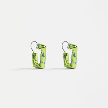 Pair of green square hoop earrings with blue speckles on a white background.