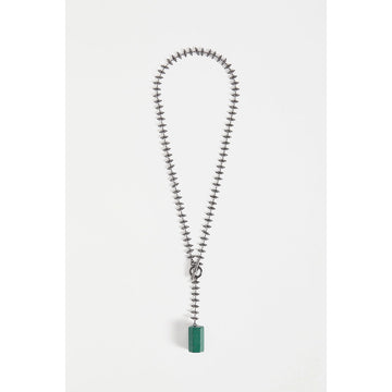 A necklace with beaded chain detail and a green block pendant.