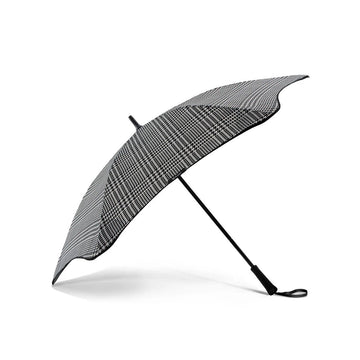 An open umbrella printed with a houndstooth pattern.