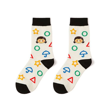 Pair of socks with colorful geometric shapes and a cartoon character on a white background.