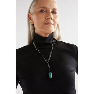 A necklace with beaded chain detail and a white block pendant.