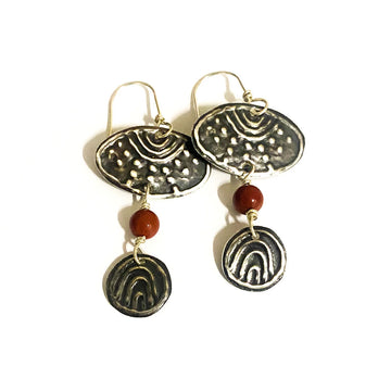 A pair of silver drop earrings featuring an oval shaped top with a Mookatite bead and round silver shape hanging below.
