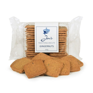 A clear packet filled with gingernut biscuits and a few biscuits in front of the packet.