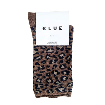 A pair of folded up lurex socks printed with leopard print and a white product tag attached.