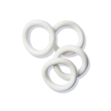 Four white ceramic napkin rings.