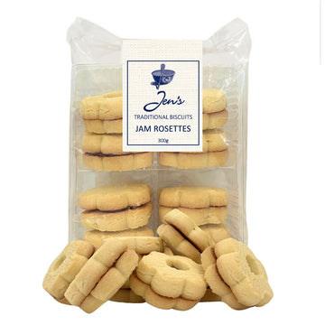A clear packet filled with flower shaped biscuits. There are a few biscuits in front of the packet.