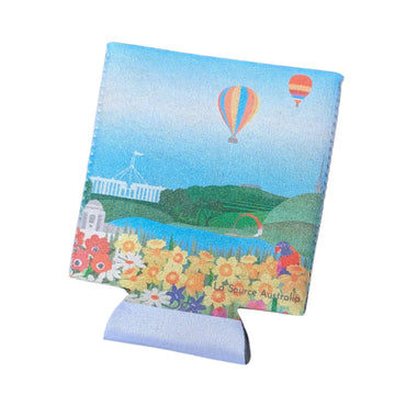 Stubby holder laying flat and illustrated with Canberra icons including Parliament House and hot air balloons.