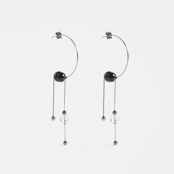 Pair of hoop earrings with black and silver beads on a white background