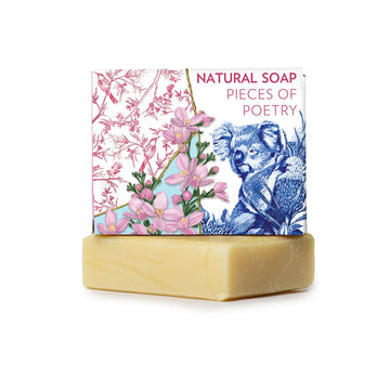 A wrapped up bar of soap with the heading 'Natural Soap Pieces of Poetry' with an illustration of a koala and flowers. There is an unwrapped bar of soap underneath.