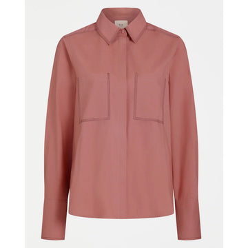 Pink shirt with two front pockets on a white background.