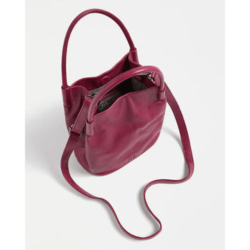 Dark pink handbag with shoulder strap on a light gray background.