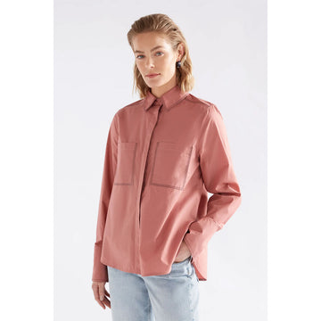 Pink shirt with two front pockets on a white background.