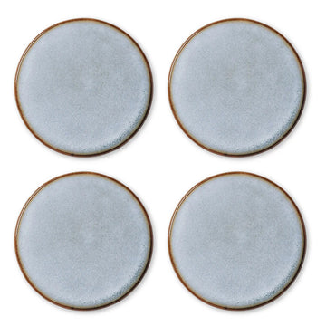 A set of four round coasters in a blue grazed texture.