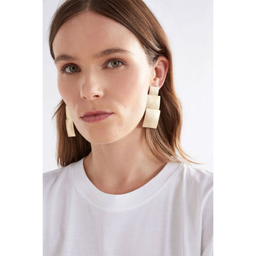 A pair of earrings featuring three different sized gunmetal grey squares.