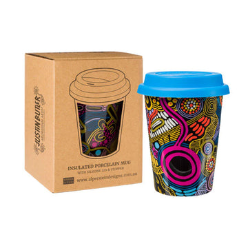 A porcelain mug printed with artwork by Justin Butler with a blue silicone lid. There is a brown box next to the mug with a cut out showing the mug inside.