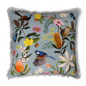 Front view of a square cushion illustrated with birds and flowers and a fringe edge.