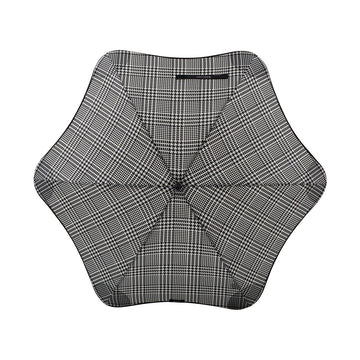 An open umbrella printed with a houndstooth pattern.