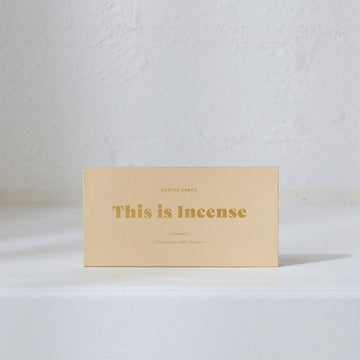 A pale yellow box with the heading 'This is Incense' written in gold across the middle.