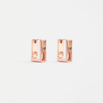 Rose gold square hoop earrings with gemstones on a light gray background.