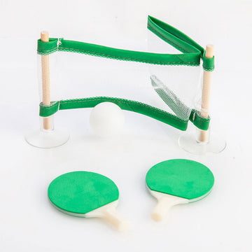 A table tennis set with a mini sized net and two green paddles.