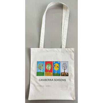 A calico tote bag with an illustration by Mick Ashley of four trees, each representing a Canberra season.