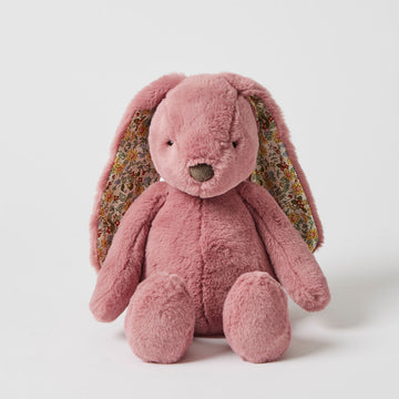 A pink bunny soft toy with floral inner ears in a sitting pose.