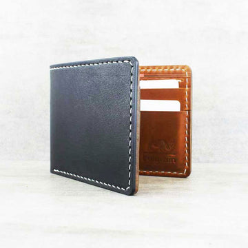Black leather wallet slightly open showing tan leather and card slots inside.