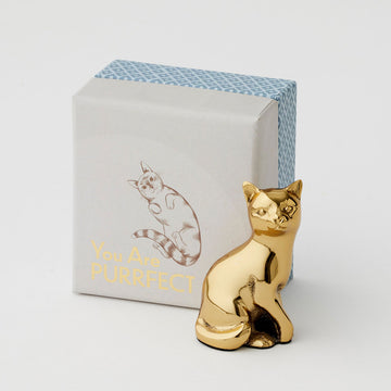 A gold statue of a cat next to a box with the text 'You Are Purrfect' written on it.