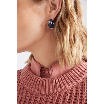 Pair of navy blue hoop earrings with silver accents on a light gray background